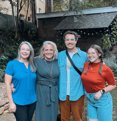 4 co-workers standing next to each other