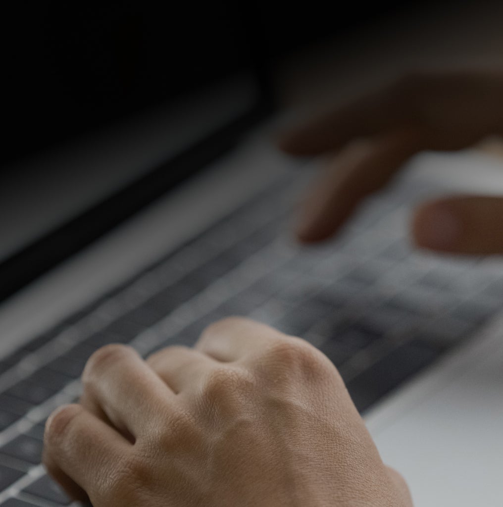 man typing on keyboard